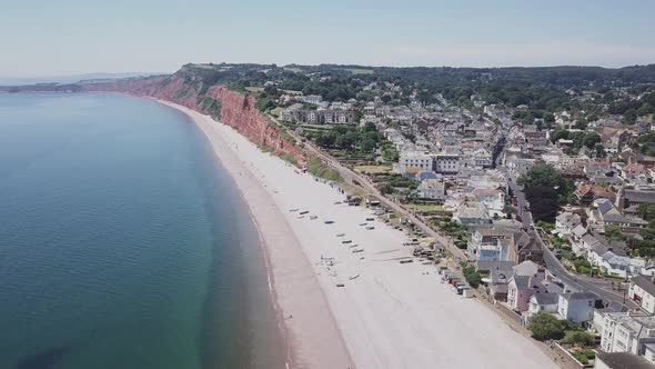Breathtaking aerial view of the town of Budleigh Salterton, pebble beach, rusty red cliffs and cryst