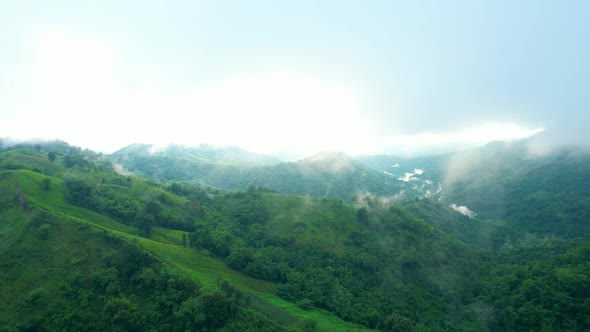 4K Aerial Drone shot flying over beautiful mountain ridge in rural jungle bush forest.