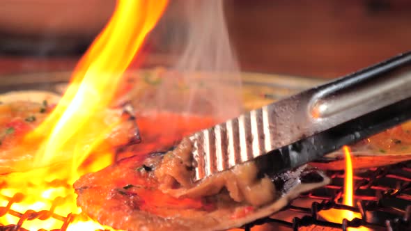 Big Fresh Scallop Shell Seafood Grill on Metal Net with Charcoal Barbecue in Korean Restaurant