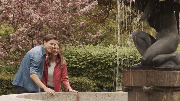 Young, happy, loving couple having date in the park. Relations, friendship and love concept.