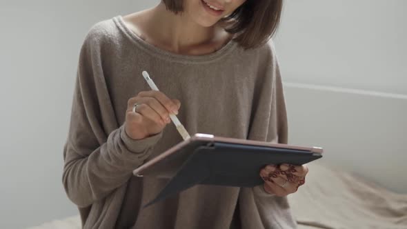 Close Up Shot of the Body of a Lady Who Is Doing Business on a Portable Tablet