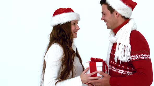 Festive couple holding christmas gift