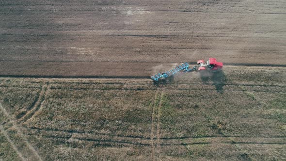 Countryside and Agriculture Grain Sowing Farm Tractors Plow the Earth in Field View From Height