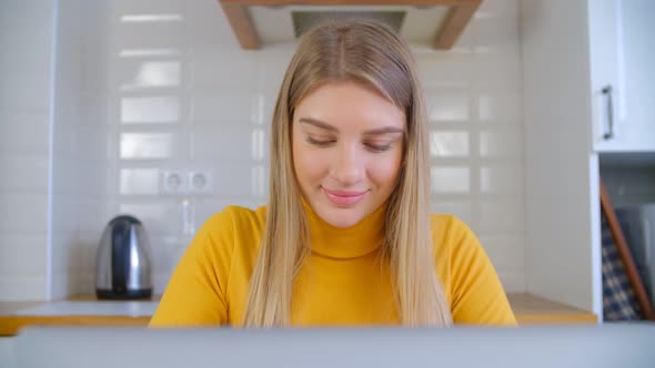 Happy freelancer woman doing distant work on laptop computer at home during lockdown in 4k video