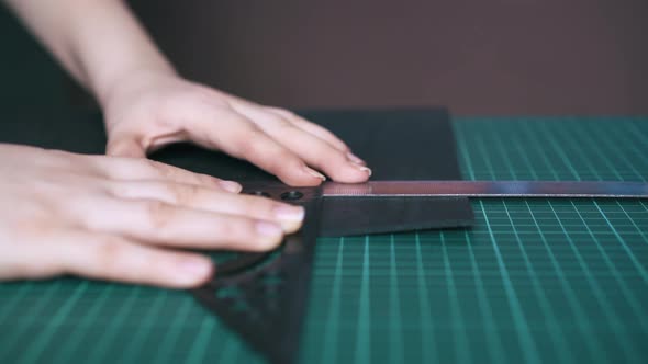 Professional Designer Measures Black Leather Cloth Closeup