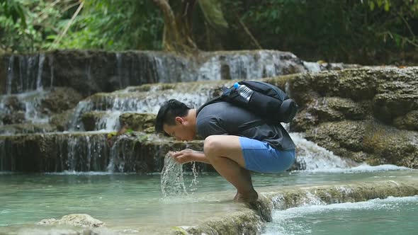 Man Washing His Face In Wild River