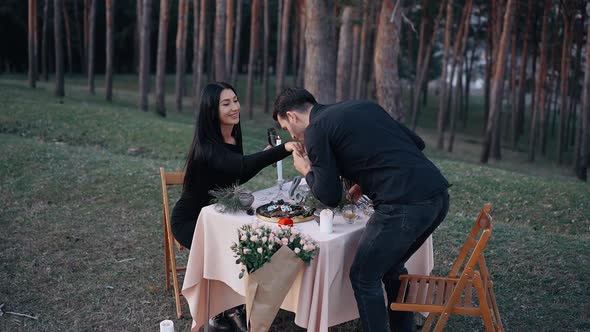 The Man in Love Kisses the Hand of the Woman He Loves with the Engagement Ring During the Romantic