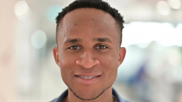 Close Up of Face of Casual African Man Feeling Smiling at the Camera