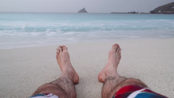 Mans Feet on Sandy Beach