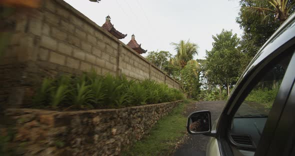 Point of View Shot of a Car Driving Through a Traditional Tropical Village in Bali Indonesia Car