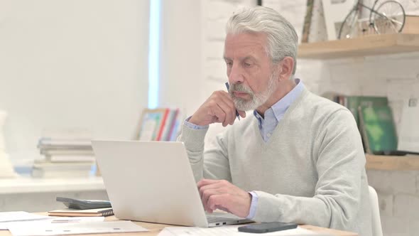 Old Man Thinking at Work