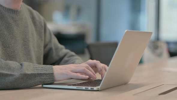 Close Up of Hands of Man Typing on Laptop