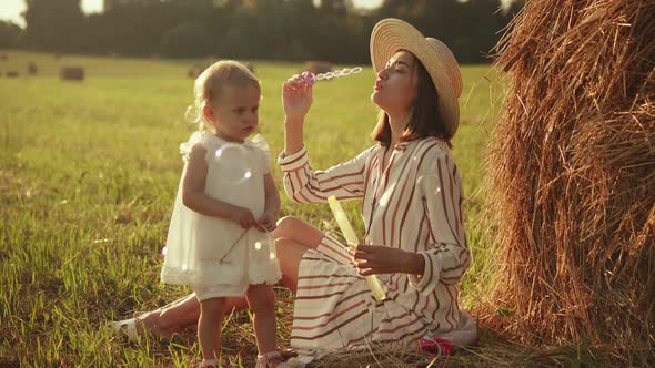 The child watches as mom goes to soap bubbles