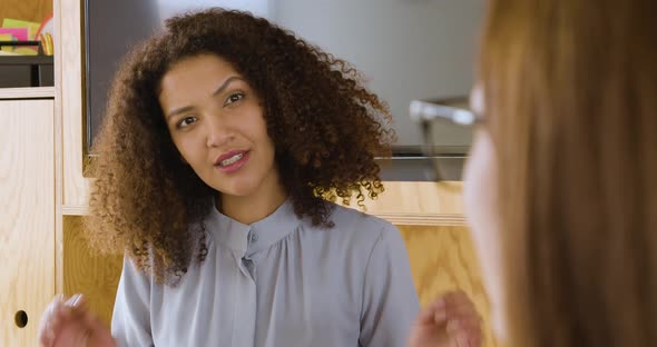 Gesturing businesswoman talking to colleague in meeting