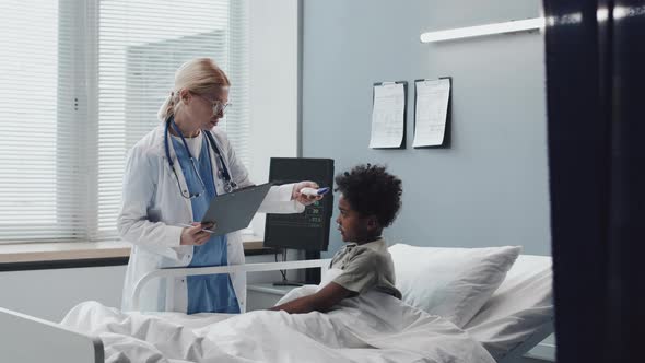 Pediatrician Checking Body Temperature of Boy