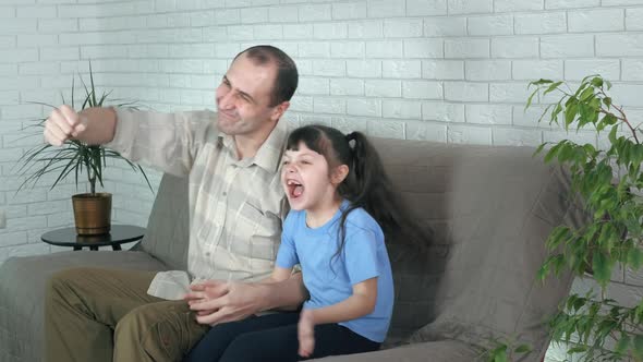 Sporty family on sofa.