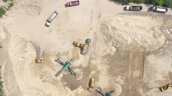 Heavy equipment machine wheel loader on sand mine. bulldozer loading sand. Aerial view