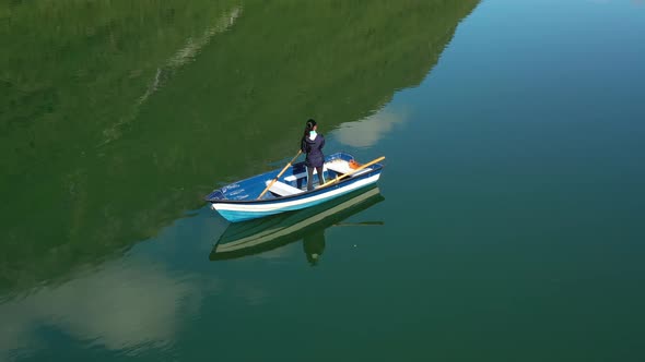 Woman on the Boat Catches a Fish on Spinning in Norway