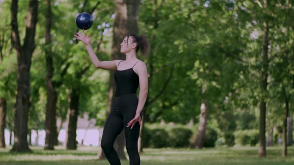 Woman Gymnast Trains with Ball