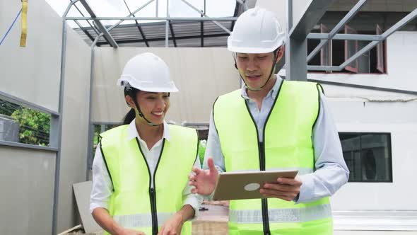 Asian construction workers people wear protective safety helmet and working onsite of architecture.