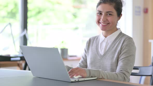 Cheerful Indian Woman with Laptop Smiling at Camera 