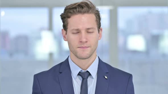 Portrait of Serious Young Businessman Saying No By Head Shake 