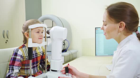 Ophthalmologist Examines the Girl on a Corneo Topographer