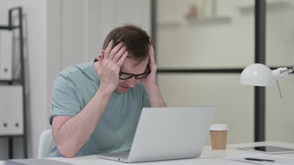 Young Man Having Headache While Working Laptop