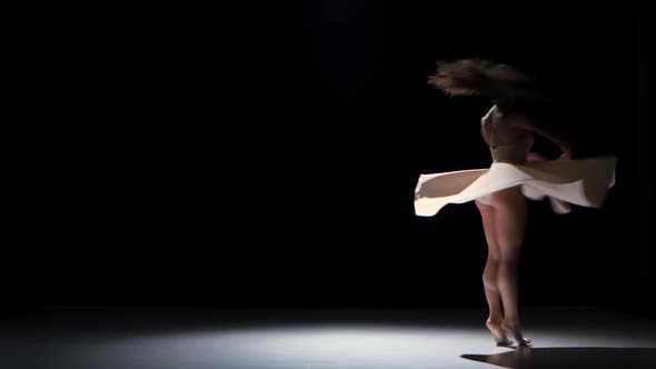 Young Woman Dancer Dancing Contemporary Dance Moves, Jumps and Makes a Split, on Black, Shadow