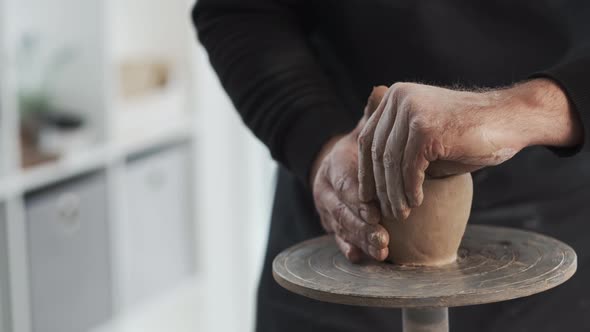 Potter Forming Cup From Clay at Workhouse