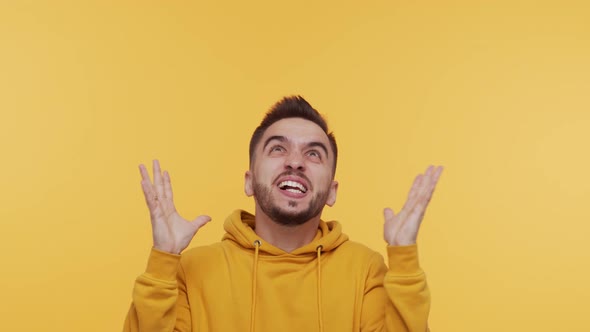 Expressive young man screaming and shouting over vibrant background.