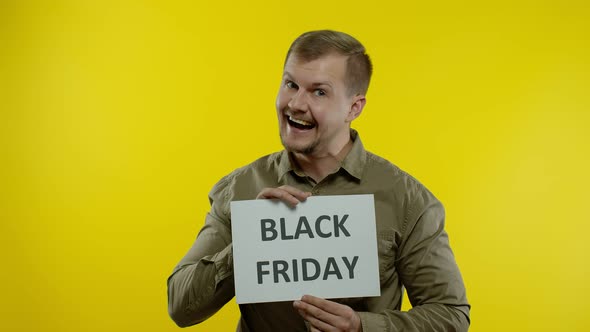 Joyful Man Showing Black Friday Inscription Note, Smiling Looking Satisfied with Low Prices