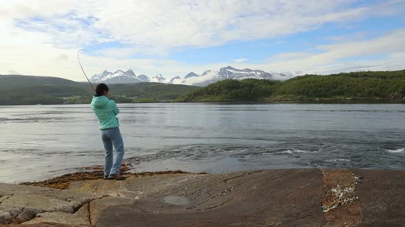 Woman Fishing on Fishing Rod Spinning in Norway