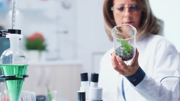Selective Focus of Biologist Analyzing Plant Samples alt