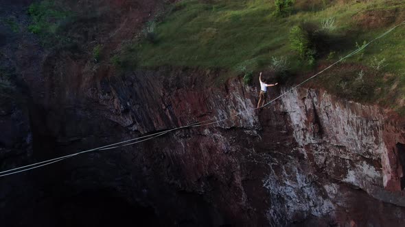 Scary Huge Pit a Man Is Walking on a Thin Rope Over It Slackline Sport