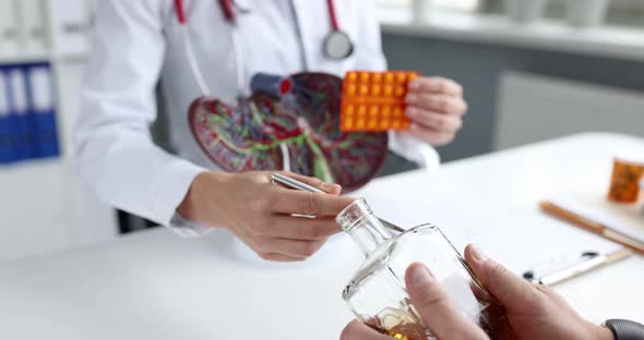 Doctor Holds Pills for Alcoholism and Treatment of Liver Closeup