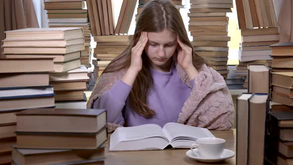 A Girl Reads a Book in the Library