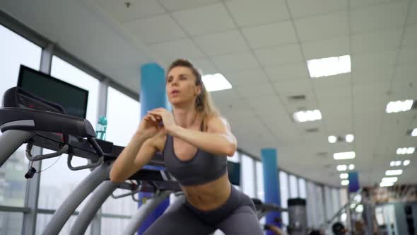 Young sporty Woman On Running Machine In Gym