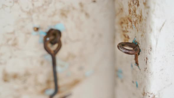 An Old Wooden Door is Closed on a Hinged Door Hook Closeup