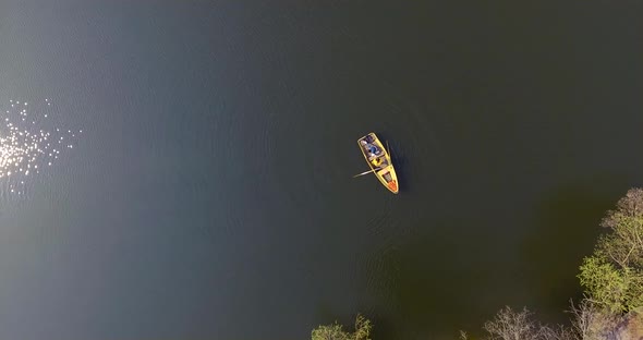 Two Girls in the Small Boat on a Beautiful Reflective River