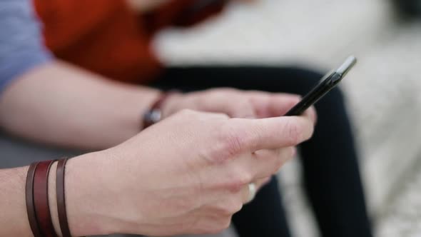 Partial View of People Using Digital Devices Outdoor