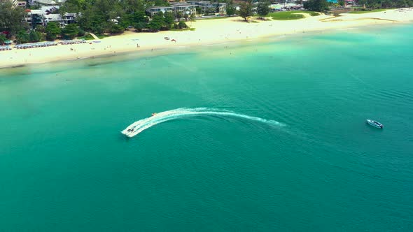 Aerial drone photo of extreme powerboat donut water-sports cruising in high speed in tropical turquo