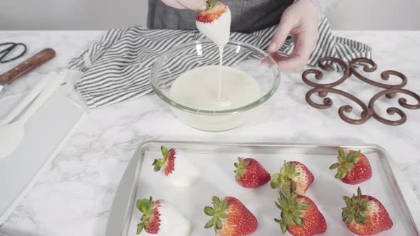 Step by step. Dipping organic strawberries into a bowl with melted chocolate to prepare chocolate co