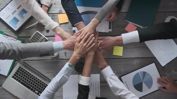 Business people stacking hands