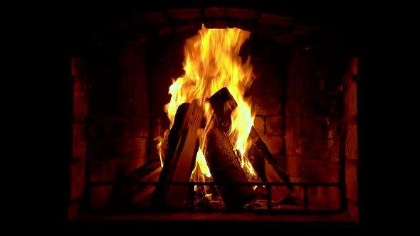 Glowing fire in home stone fireplace