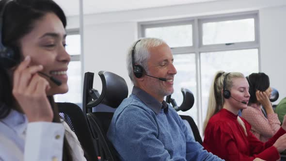 People wearing headset working while sitting on their desk at office