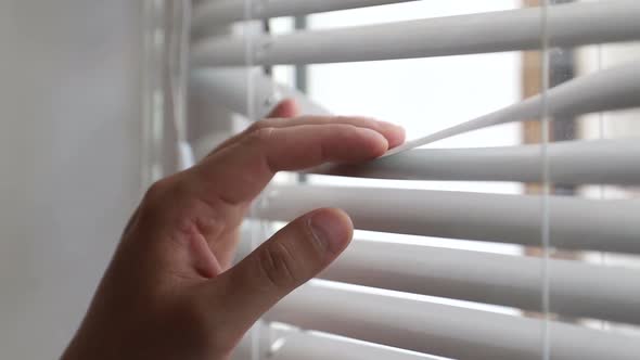 Man Spying on People Using Binoculars for Observation