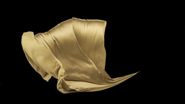 Yellow fabric flowing on black background, Slow Motion