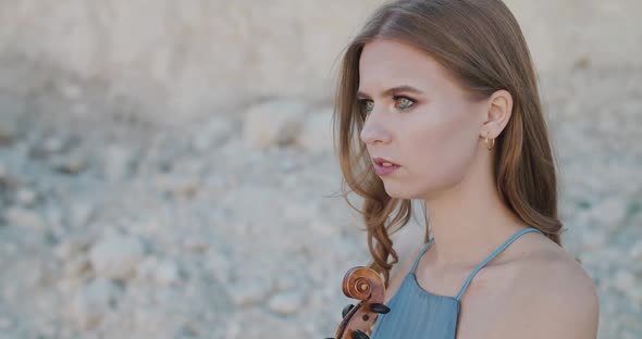 The Woman Coming at Female Violinists, Who Looks Thoughtfully at Cliffs