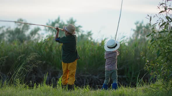 Summer Vacation Adorable Little Children with Fishing Rods in Their Hands Fish in Pond While